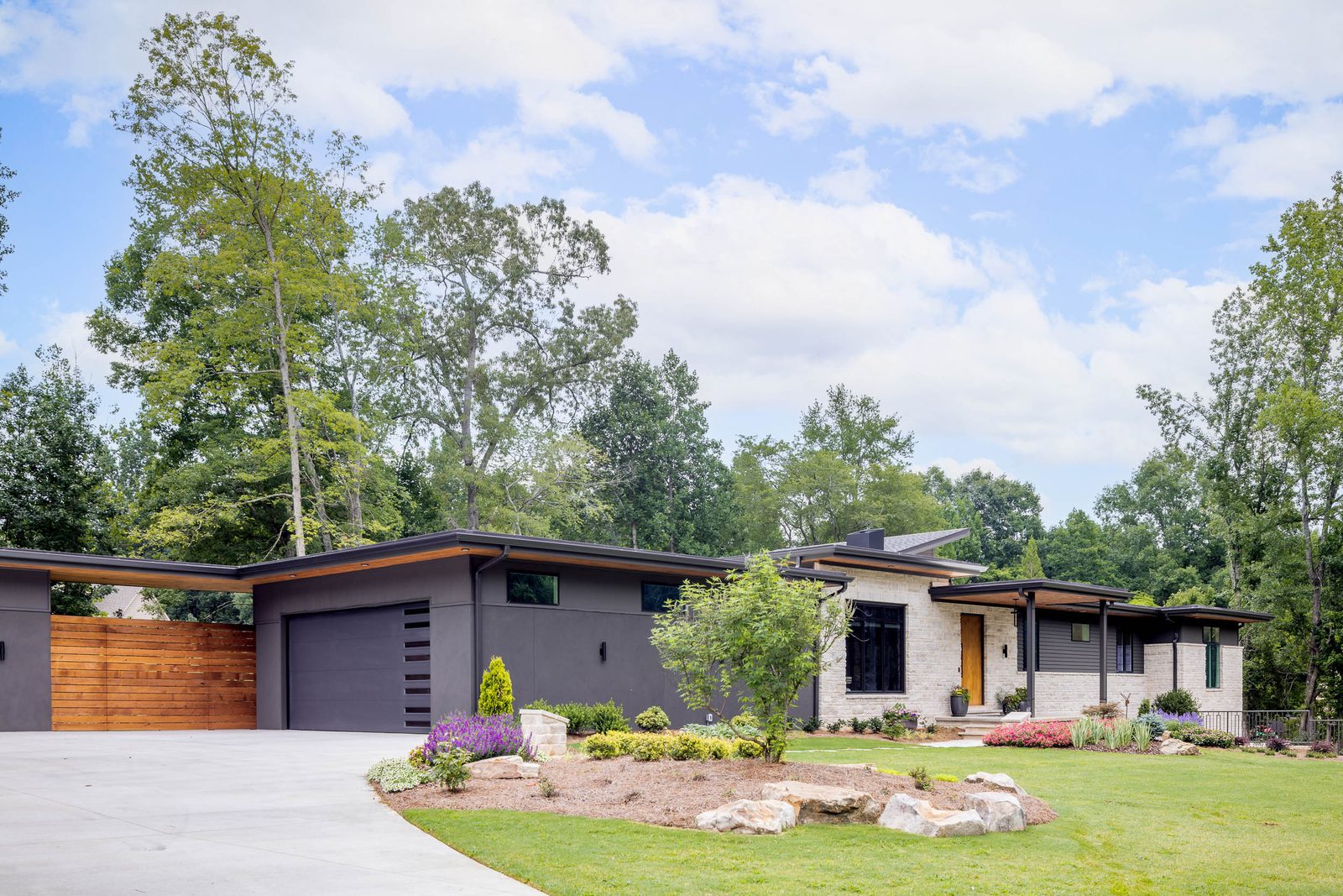 Detached garage with cedar screen wall and drive court — The Ortiz Home, custom home built by Ironwood Construction Group in Sugar Hill, Georgia