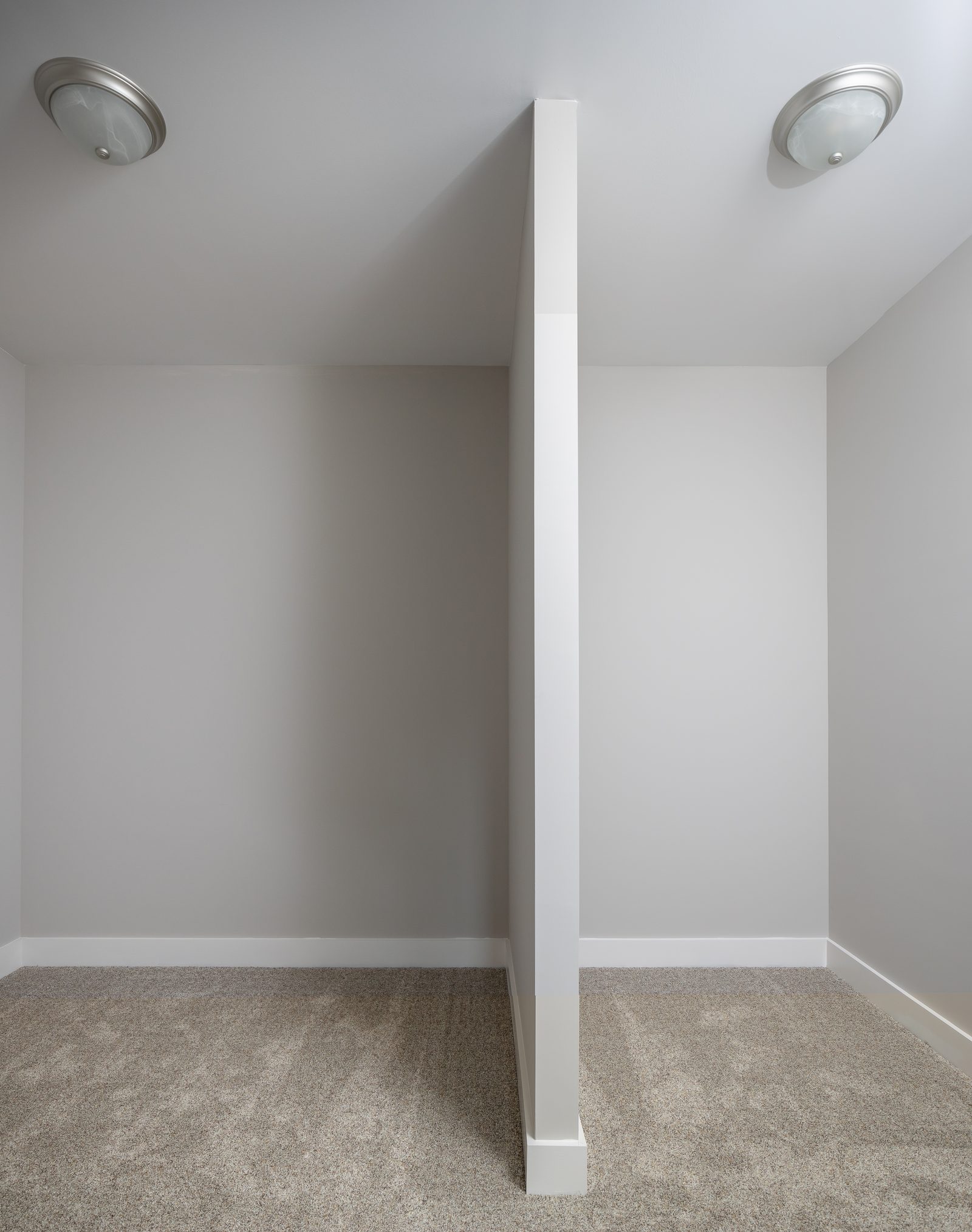 Carpeted storage alcove beneath the eaves — Shadburn Ferry, custom home built by Ironwood Construction Group in Buford, Georgia